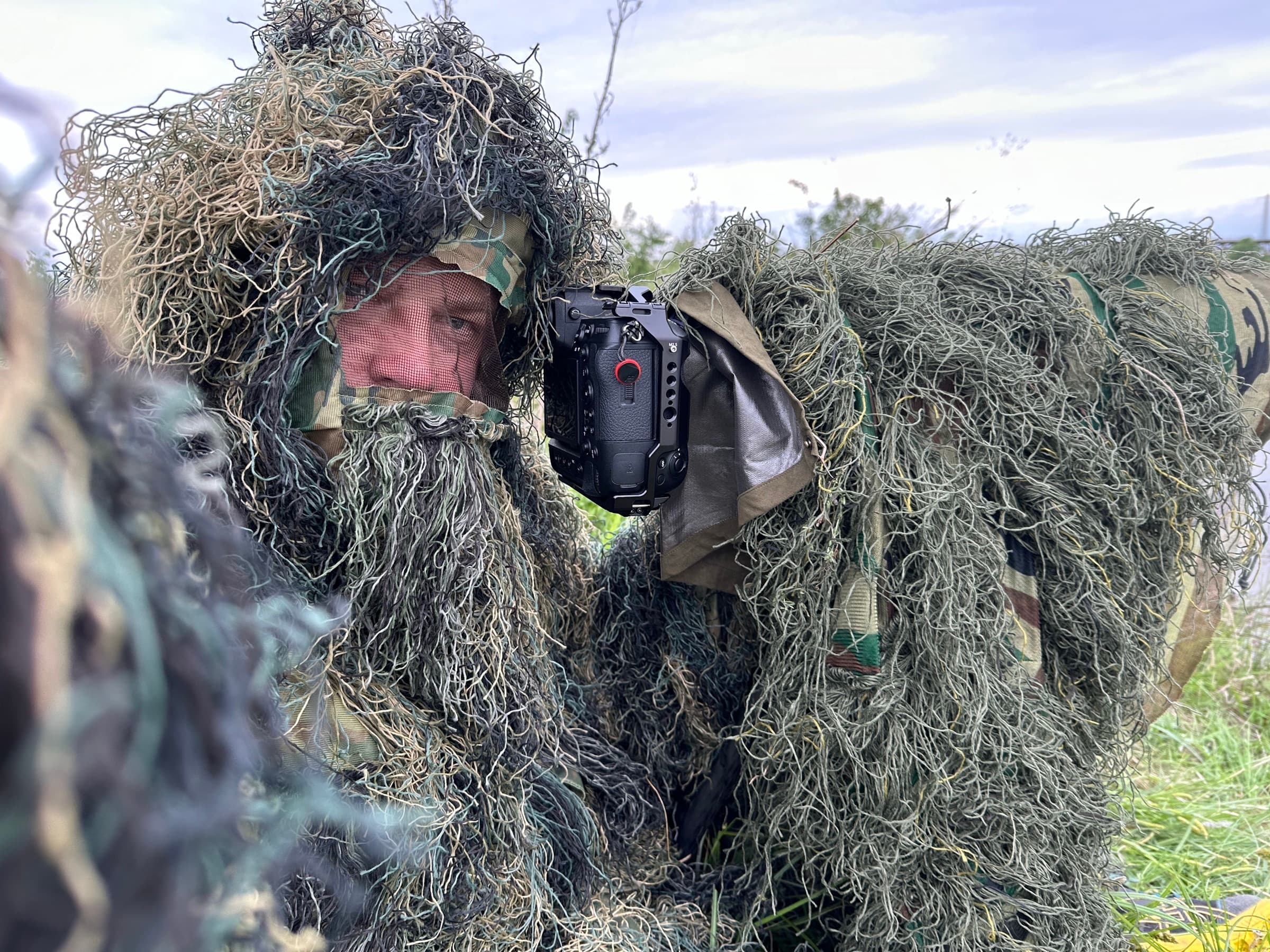 Wildlife photographer in a ghillie suit